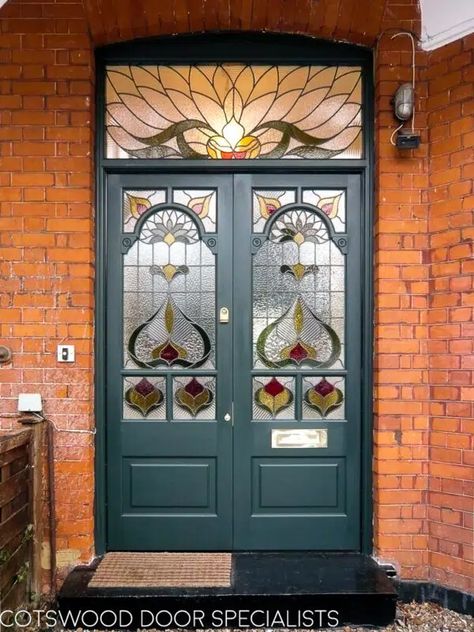 An outstanding pair of decorative Edwardian double doors. The stained glass is the star of the show, combining shaped and square panes with coloured and textured glass to breathtaking effect. The central shaped glass panels feature corner mouldings with unusual circular details, adding to the intricate feel of the doors. Overhead, a large rectangular fanlight crowns the stained glass design with an extravagant floral motif. Painted a rich forest green. Double Front Entry Doors, Victorian Front Doors, Leadlight Windows, Corner Moulding, Stained Glass Door, Double Front Doors, House Extension Design, Wood Front Doors, Exterior Front Doors