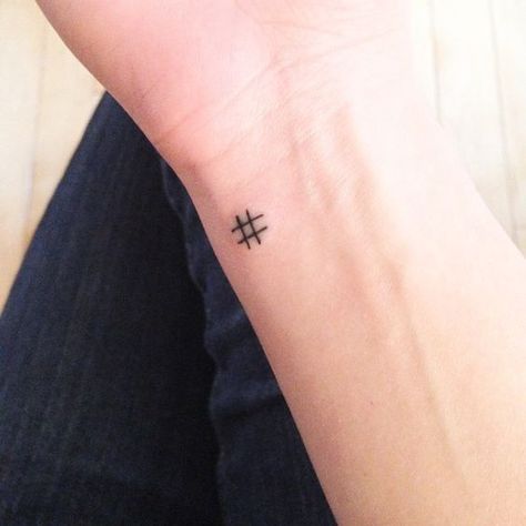 Hashtag symbol tattoo on the wrist  Tiny hashtag symbol tattoo on the left side of the inner wrist Tattoos Masculinas, Small Symbol Tattoos, Small Rib Tattoos, Tato Tradisional, Quote Tattoos Girls, Tato Dengan Makna, Tato Jari, Flower Wrist Tattoos, Small Tattoos With Meaning