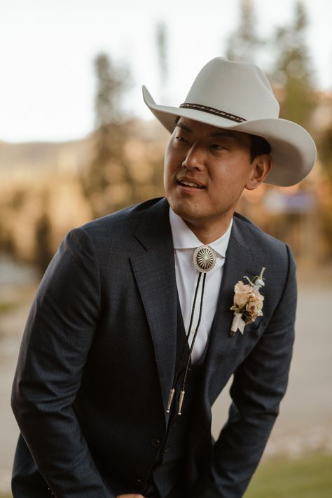 A Modern-Meets-Western Wedding in the Mountains Of Colorado Wedding Bolo Tie Grooms, Bolo Tie Wedding Groom, Pastel Flower Centerpieces, Black Canyon Inn Wedding, Suits Groom, Wedding In The Mountains, Hacienda Wedding, Mens Wedding Attire, Dark Suit