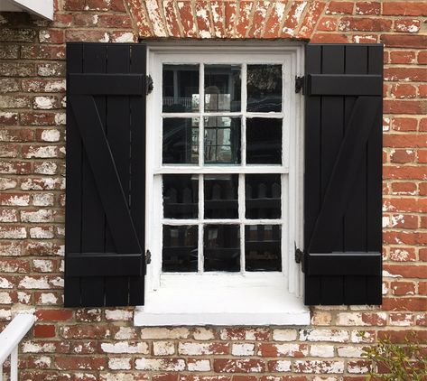 These black board and batten shutters feature a z-brace on ether side, functional hardware, and black shutter capping. #shutters #timberlaneshutters #blackshutters #boardbattenshutters Black Exterior Shutters, Craftsman Shutters, Cottage Shutters, Front Entrance Decor, Farmhouse Shutters, Mission Style Homes, Painting Shutters, Louvered Shutters, Black Shutters