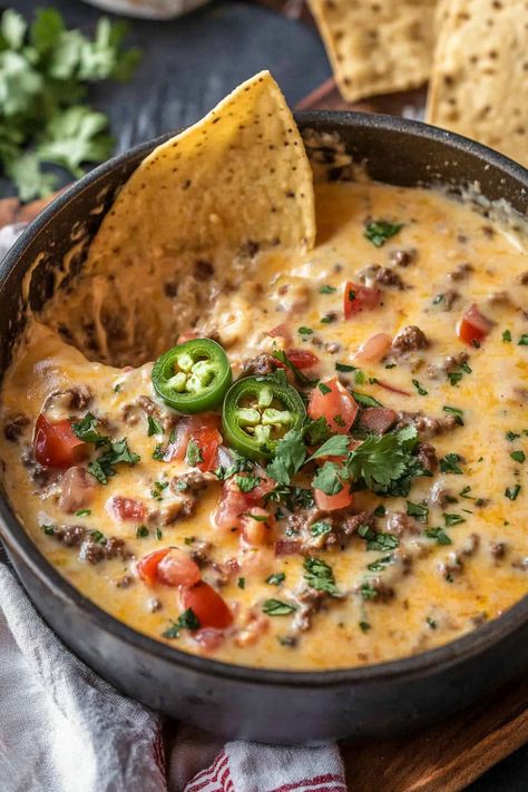 Cowboy Queso – a hearty, chunky queso dip bursting with flavor from green chiles, roasted tomatoes, ground sausage, and smoked cheddar sausage. It’s the perfect dip for feeding a hungry crowd on game day or at a tailgate, and pairs perfectly with an ice-cold Dr Pepper! This loaded Velveeta Queso has everything a cowboy craves: Queso Dip Easy, Cowboy Queso, Cheese Queso Dip, Queso Dip Velveeta, Sausage Queso Dip, Mexican Cheese Dip, Queso Dip Crockpot, Sausage Queso, Velveeta Queso