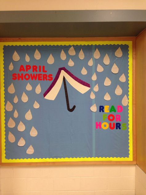 Bulletin board: April Showers, Read For Hours. Raindrops made from book pages. April Showers Read For Hours Bulletin Board, April Showers Bulletin Board, April Library Bulletin Boards, Umbrella Bulletin Board, April Library Displays, Spring Whiteboard Ideas, April Bulletin Board Ideas, Media Center Decor, April Bulletin Boards