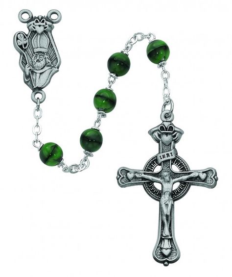 The centerpiece is unique as it is a bust of St. Patrick holding his Bishop's staff with shamrock and Irish friendship symbols. Beautiful green round beads are paired with an open cut Celtic crucifix with heart tips. The Length is 22 inches Crucifix Measurement 1.91 x 1.22 x 0.17 inches Crucifix Material is Pewter Centerpiece Measurement 1.18 x 0.58 x 0.08 inches Centerpiece Material is Pewter Glass beads are used for this rosary Bead size is 7 mm Bead color is Green Packaged in a deluxe gift bo Mens Rosary, Prayer Jewelry, Rosary Boxes, Green Shamrock, Irish Jewelry, Green Beads, Birthstone Pendant, Silver Wedding Rings, Rosary Beads