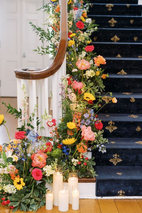 Colorful Floral Arrangement for Winding Staircase with candles Stair Flowers Wedding, Flower Staircase, Colorful Floral Arrangement, Wedding Stairs, Colorful Weddings, Winding Staircase, Dream Wedding Decorations, Bright Flowers, Staircase Design