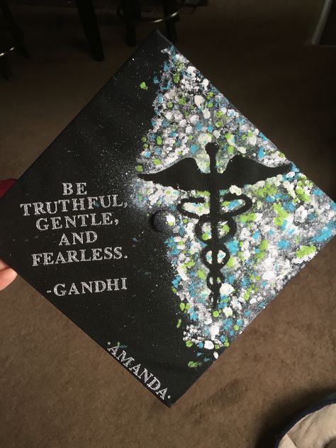 My nursing graduation cap decorated with a splatter paint caduceus and Gandhi quote. Bsn Graduation Cap, Nurse Graduation Cap Designs, Nursing Graduation Cap, Citation Gandhi, Nursing School Graduation Party, Nurse Graduation Cap, College Grad Cap Ideas, High School Graduation Cap, College Graduation Cap Decoration