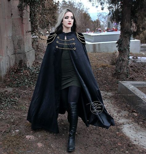 This long black cape is a new addition to my Etsy shop! Link in bio. 💖 It is fully lined and has epaulettes decorated with golden filigrees as well as 3 golden chains in the front. Do you like it? Let me know in the comments!  Cape & model: @maria.heller.designs  #blackcape #longcape #blackcloak #victoriangoth #militarycoat  #gothicstyle #gothstyle #gothicfashion #gothfashion #gothiccape #gothiccloak #gothiccoat #gothcape #gothcloak #gothcoat #blackcloak #witch #militarystyle #gothgirl #gothicg Victorian Cloak, Cape Fantasy, Fantasy Cape, Gothic Cape, Cape Outfit, Black Cloak, Cape Designs, Black Cape, Cool Baby