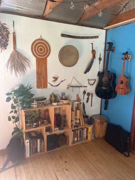 Shaman’s instrument and shaker display with wood crate bookshelves. Turn instruments and trinkets into beautiful, homey decor. Hanging guitar, ukulele, drum, yarn mandala, singing bowls, wood flute, wind chimes, tarot, tepi, kuripe display. Hanging Instruments On Wall, Instrument Organization, Crate Bookshelves, Wood Flute, Hanging Guitars, Display Living Room, Instrument Display, Yarn Mandala, Fancy Furniture