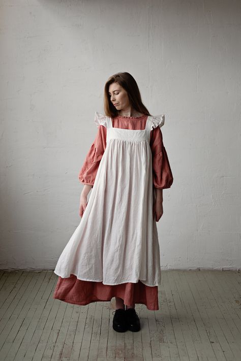 Victorian style inspired pinafore dress with flutter sleeve made from 100% soft and washed Oeko-Tex certified linen Details: - Composition: 100% Oeko-Tex certified linen - Colour: White - Coconut buttons down the back - Size: XS-S, M, L-XL - Medium weight linen - Linen care: machine wash gentle; tumble dry low, ironing optional - The price is for one pinafore dress, other pictured items are not included Dress With Wings, Linen Apron Dress, Apron White, Dress With Flutter Sleeves, Linen Pinafore, 여름 스타일, Dress Linen, Oversized Dress, Apron Dress