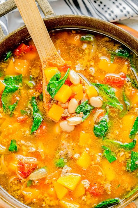 Butternut Squash and Sausage Soup - 🍲🧡😋 Along with cubes of tender butternut squash and a bit of spice from Italian sausage, this hearty soup has white beans, fire-roasted tomatoes, and spinach to make it filling and flavorful! EASY, ready in 30 minutes, and perfect for chilly weather! Hearty enough to be a meal unto its own. This soup freezes very well so you can make a batch and freeze some for later. Squash And Sausage Soup, Squash Soup With Sausage, Soup With Sausage And Spinach, Butternut Squash And Sausage, Slow Cooker Butternut Squash Soup, Fish Pasta, Sausage Soup Recipes, Italian Sausage Soup, Chicken And Butternut Squash