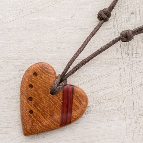 Decorated with a stripe of estoraque wood a heart is hand-carved from madrecacao wood with a beautiful natural grain. Costa Rican artisan Milagro Cascante creates this love-inspired pendant necklace which is decorated with four divots. This necklace circles the neck with an adjustable length of cotton cord. Wood Carved Necklace, Heart Necklace Diy, Sculpture Dremel, Wood Heart Necklace, Wood Necklace Pendant, Wood Jewelry Diy, Wooden Jewelery, Pmc Jewelry, Primitive Wood Crafts