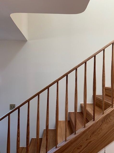 Architectural Digest Staircase, Tapered Stair Spindles, Wooden Rails For Stairs, White Oak Bannister, Simple Wood Stair Railing, Mid Century Banister Stair Railing, Wooden Stair Banister, Midcentury Modern Stair Railings, Scandi Staircase