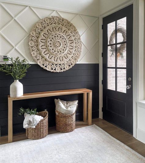 Greeted by a striking black entrance door, this farmhouse-styled entryway draws attention with its bold black-and-white shiplap design. An artfully hung large woven circular artwork rests above the wooden table with plants and woven baskets. Foyer Ideas Entryway, Entryway Wall, Entry Way Design, Home Entrance Decor, Updating House, House Entrance, How To Decorate, New Wall, Entryway Decor