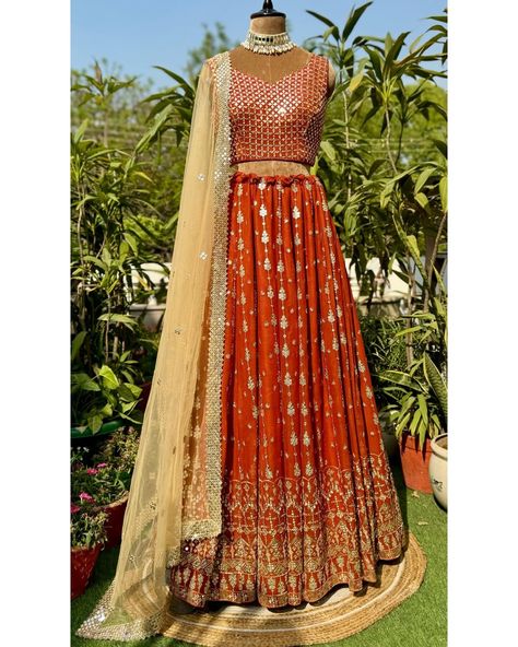 Shiny sequins are embroidered in a linear pattern on this beautiful rust lehenga. Statement embroidered blouse is a sure head turner. It’s perfect glamorous outfit for the festive/wedding season. To place your order DM or WhatsApp us at 9971767771. It can be customised in any colour of your choice. [mirror embroidered lehenga, rust lehenga, bridesmaid outfit, Indian wedding dress, bride to be] #labelsnigdhakapoor #lehenga #indianwedding #rustlehengacholi #mirrorlengha #mehendioutfit #sang... Rust Lehenga, Outfit Indian Wedding, Lehenga Bridesmaid, Outfit Indian, Mehendi Outfit, Bride’s Mother, Wedding Dress Bride, Sangeet Outfit, Glamorous Outfits