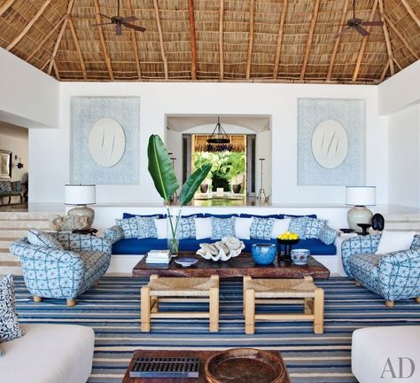 At a Mexican beach house by Martyn Lawrence Bullard, the living room sofa, with seat and back cushions of Chameleon fabric by Perennials, is flanked by custom-made chairs upholstered in Kaba Kaba linen by Bullard. Niches in the rear wall display Bali-inspired stenciling by artist Kelly Holden. Beach House Interior Living Room, Mexican Beach House Decor, Lake House Decor Living Room, Mexican Beach House, Mexican Beach, Beach House Interior Design, Dream Beach Houses, Mexican Home, Beach House Interior