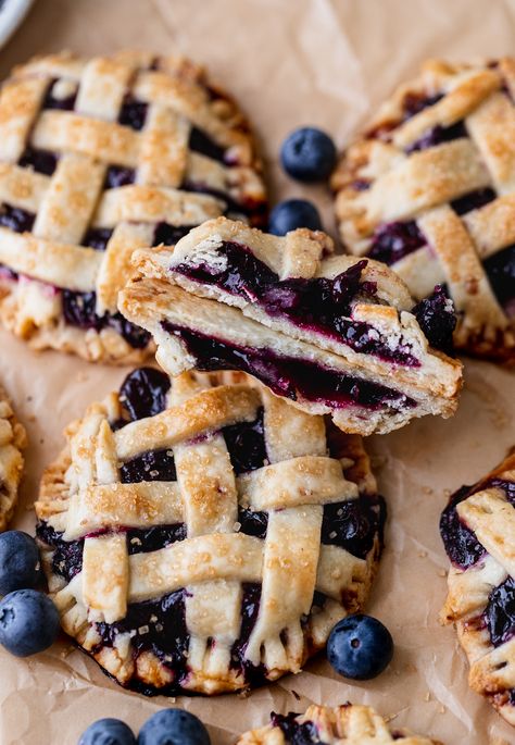 These mini blueberry pies are small pies you can hold in your hand! They have flaky pie crust with lattice work on top. In the middle is a blueberry pie filling with a little bit of cinnamon. If you are looking for an easier version of blueberry pie, these are for you! Easy Flaky Pie Crust, Mini Blueberry Pies, Blueberry Pies, Blueberry Pie Filling, Blueberry Desserts, Flaky Pie Crust, Blueberry Pie, Blueberry Recipes, Mini Pies