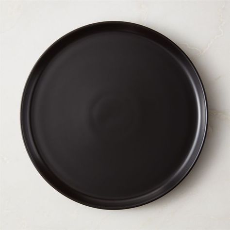 Crafted of porcelain for tradition and durability, minimalist dinner plate from award-winning Japanese designer Ryuichi Kozeki easily transitions from casual to formal settings. Featuring clean, raised edges, the modern silhouette is glazed by hand in sleek black for an elegant finish with a soft sheen. For a coordinated table, pair with the other pieces in the Mori dinnerware and serveware collections. CB2 exclusive.  -Handmade -Designed by Ryuichi Kozeki -Porcelain with black glaze -Flatware m Minimalist Dinner, Black Tableware, Black Dinner, Bar Keeper, Table Ware, Black Glaze, Aesthetic Life, Black Rims, White Plates