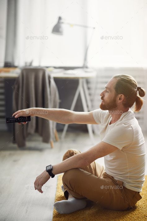 Contemporary Man Watching TV on Floor by seventyfourimages. Side view portrait of modern young man switching channels while watching TV at home sitting on floor #Affiliate #Side, #seventyfourimages, #portrait, #view Tv On Floor, Man Sitting On Floor, Man Watching Tv, Side View Portrait, Sitting On Floor, Man Sitting, Person Sitting, Watching Tv, Side View