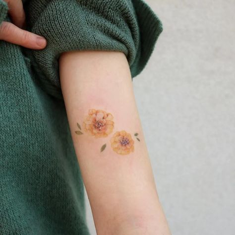 Beautiful Annual Blooms: Birth Month Flower Tattoos | Tattoodo Month Flower Tattoo, Marigold Tattoo, Cosmos Tattoo, Marigold Color, October Flowers, Flower Tattoo Ideas, Korean Tattoos, Beautiful Flower Tattoos, Aries Tattoo