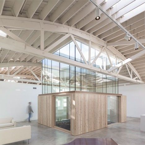 Works Partnership Architecture converted a warehouse in Portland into a home and studio by punching skylights through the preserved bowstring truss roof and inserting living quarters within timber-clad boxes Portland Architecture, Warehouse Conversion, Timber Roof, Warehouse Design, Internal Courtyard, American Houses, Industrial Architecture, Roof Trusses, Repair Shop