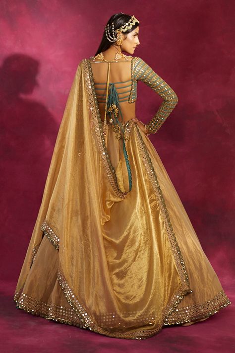 Gold high-waist lehenga with mirror embroidered motifs on waistline and hem. Comes with blouse and sheer dupatta. Component: 3 Embroidery Neckine: Sweetheart Sleeve Length: Full Fabric: Blouse: Georgette; Lehenga and Dupatta: Tissue Color: Gold Hand embroidery Scallop hem on lehenga Sequin embroidered motifs on blouse Deep back on blouse with tassel tie-up detail Scallop border on dupatta with mirror embroidered motifs - Aza Fashions Gold Lehenga Skirt, Dark Green Prom Dresses, Vani Vats, Gold Lehenga, Designer Bridal Lehenga Choli, Mehendi Outfits, Georgette Lehenga, Wedding Lehenga Designs, Lehenga Designs Simple