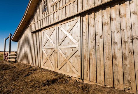 Post and beam barn with board and batten siding. Wood Look Steel Siding, Barn Siding Exterior, Barn Exterior, Barn Remodel, Tractor Barn, Board And Batten Exterior, Barndominium House, Post And Beam Barn, Stable Ideas