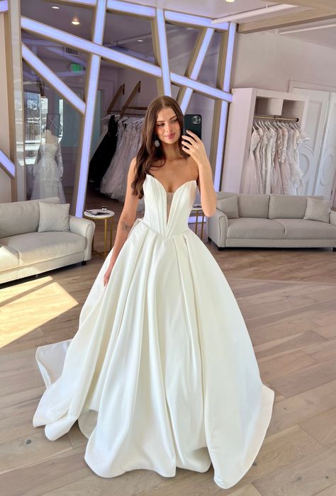 Derrick by Maggie Sottero is drama! With a plunging v-neckline and exposed boning, this bold beauty is sure to make a lasting impression! #weddingdress #deepvneckline #ballgown Maggie Sottero Ballgown, Maggie Sottero Derrick, Beautiful Ballgown, Plunging Neckline Wedding Dress, 2026 Wedding, Wedding Ballgown, Maggie Sottero Bridal, Short Engagement, Modern Gown