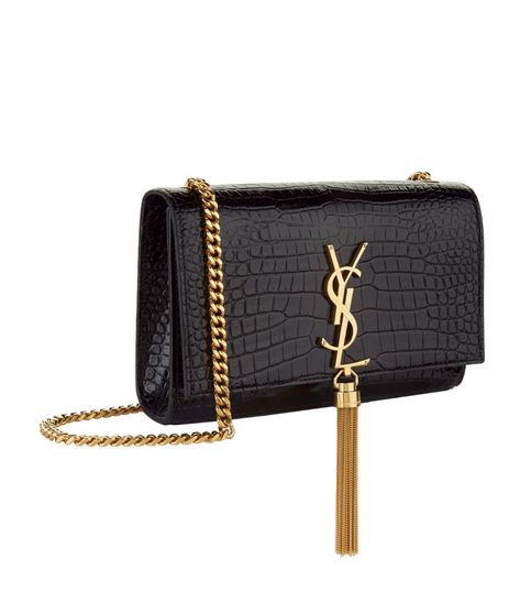 Find SAINT LAURENT Small Kate Tassel Croc-embossed Shoulder Bag on Editorialist. The Saint Laurent Kate shoulder bag is crafted from croc-embossed leather and features the iconic YSL logo lettering, a heritage tassel, and a flap opening. The interior is the perfect size for a mobile phone and lipstick. The bag can be worn as a shoulder bag or a clutch. It comes with a chain strap. Ysl Wallet On Chain, Ysl Crossbody Bag, Ysl Wallet, Ysl Saint Laurent, Ysl Logo, Tassel Bag, Chain Bag, Small Shoulder Bag, Chain Bags