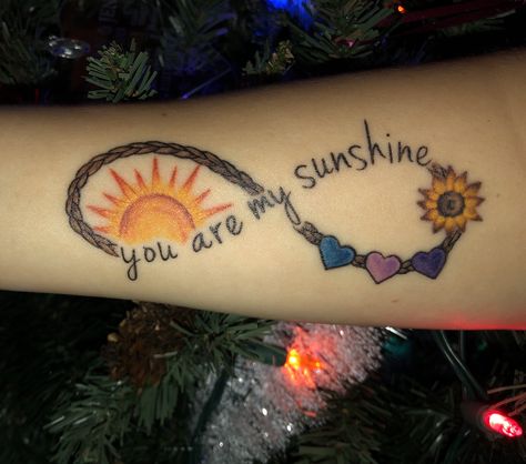 My “you are my sunshine” infinity rope birthstone heart tattoo My Sunshine Tattoo, Sunshine Heart, Sunshine Tattoo, Mom Daughter Tattoos, Tattoos With Kids Names, Omerta Tattoo, Mother Tattoos, Tattoo For Son, Sun Tattoos