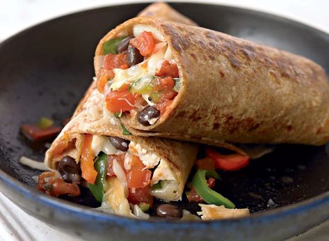 When the Mexican food cravings hit, you don't have to order in a calorie-heavy meal. Our healthy chicken burrito recipe is quick and easy to make at home. Chicken Fajita Burrito, Fajita Burrito, Burrito Recipe Chicken, High Protein Lunch Ideas, Costco Rotisserie Chicken, Low Calorie Lunches, Eat This Not That, Chicken Fajita, Chicken Burritos