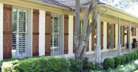 Related image Brown Shutters, Brick Ranch Houses, Porch Pillars, Cedar Shutters, Ranch House Exterior, Painted Brick House, House Shutters, Brick Ranch, Home Exterior Makeover