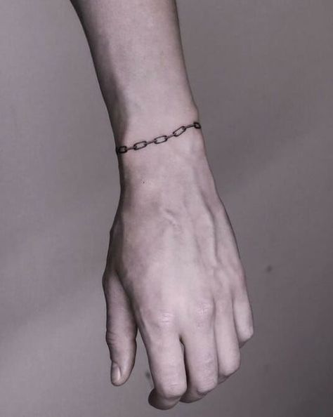 Chain bracelet tattoos are a popular choice for both men and women. Find inspiration for your next tattoo with these 52 unique designs. #chainbracelettattoo #bracelettattoo . #Chain_Bracelet_Tattoo_Wrist #Chain_Tattoo_Design_For_Women #Bracelet_Hand_Tattoo #Mens_Bracelet_Tattoo Hand Tattoo Bracelet, Chain Around Wrist Tattoo, Chain Bracelet Tattoo Wrist, Bracelets Tattoo Men, Red Line Wrist Tattoo, Fine Line Chain Tattoo, Bracelet Hand Tattoo, Broke Chains Tattoo, Mens Bracelet Tattoo