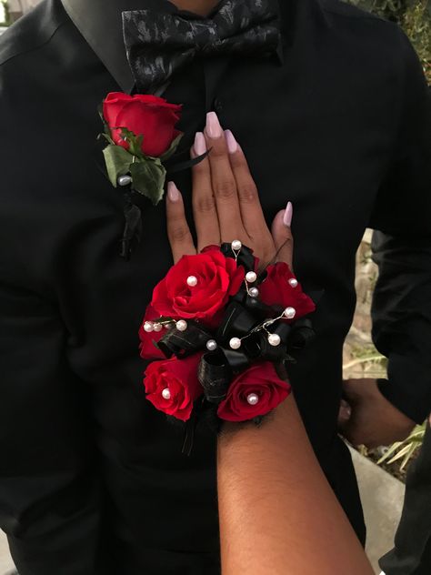 Red roses, all black ribbons with white pearls Red Black Corsage, Red And Black Prom Corsage, Black And Red Prom Flowers, Black And Red Boutonniere, Red Flower Corsage, Red Rose Corsage And Boutonniere, Red Hoco Flowers, Red And Black Corsage And Boutonniere, Prom Corsage And Boutonniere Red