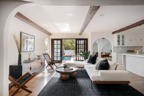 Living Room Pool View, Spanish Interior Design Living Room, Living Room Pool, Sliding French Doors, Courtyard Pool, Hardwood Floors Dark, Los Angeles Real Estate, Hollywood Homes, Wood Beam Ceiling