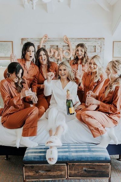 Ask a Real Bride: How Much Can I Ask My Bridesmaids to Spend? Bridesmaid Pjs Pajama Set Fall, Satin Pajamas Bridesmaids, Terracotta Bridesmaid Pjs, Bridal Party Bed Photo, Bridal Party Getting Ready Pajamas, Bride With 6 Bridesmaids, Bride And Bridesmaid Matching Pajamas, Bridesmaid Pajamas Winter, Matching Bridesmaids Pajamas