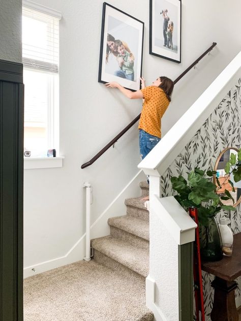 Tips and tricks for hanging photos going up your stairs Pictures Going Up Staircase, Pictures Up Staircase, Photos Up Staircase, Top Of Stairs Decor Upstairs Landing, Top Of Stairs Decor, Hanging Family Pictures, Pictures On Stairs, Stairway Pictures, Hallways Ideas