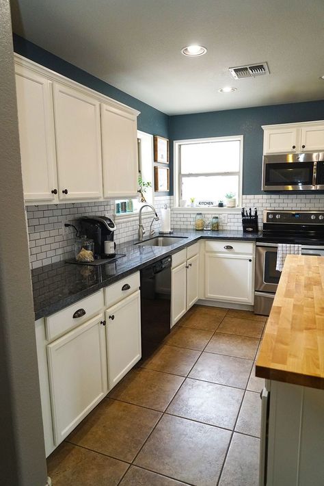 I love this beautiful kitchen transformation! The kitchen feels so bright and airy with the subway tile, butcher block island, and white cabinets. It has a nice farmhouse feel with the blue walls. #subwaytile #farmhousekitchen #kitchenrenovation #diykitchen Dark Kitchen Walls With White Cabinets, Kitchen Blue Walls White Cabinets, Kitchen Gray Walls White Cabinets, Farmhouse Kitchen Blue Walls, Kitchens With Blue Walls, Slate Blue Kitchen Walls, Painted Kitchen Walls Ideas, Blue Walls White Cabinets Kitchen, Light Blue Kitchen Walls White Cabinets