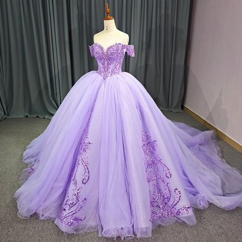 Exquisite quinceañera dress in a stunning purple hue, perfect for 2024 celebrations. Features an elegant empire waist that enhances the feminine silhouette. Designed with a dramatic long tail for added sophistication and grandeur. Crafted from high-quality materials for a luxurious and comfortable feel. Adorned with intricate detailing that adds a touch of elegance and refinement. Ideal attire for quinceañeras, Sweet 16 parties, and other special occasions. Flattering fit that combines modern st Gold And Purple Quinceanera Dresses, Purple Dresses Quinceanera, Lavender Ball Gowns, Dark Purple Quinceanera Dresses, Light Purple Quinceanera Dresses, Purple Quince Dress, Purple Wedding Gown, Wedding Veil Blusher, Purple Quinceanera Dresses