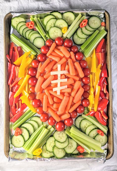 It's easy to make this adorable football veggie tray for your next watch party! Made with fresh veggies in the shape of a football. Veggie Tray Football Party, Football Vegetable Tray, Football Stadium Veggie Tray, Tailgate Veggie Tray, Football Party Foods For Kids, Charcuterie Board Ideas Football, 40th Football Birthday Party, Football Birthday Party Snacks, Football Fruit Tray