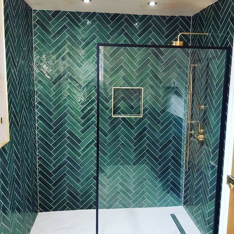 Green bathroom tile, herringbone, brass shower fixtures, wetroom base, porcelain floor. Forest Green Bathroom Tile, Green And White Downstairs Toilet, Green Herringbone Bathroom Tiles, Green Herringbone Shower Tile, Emerald Green Tiled Bathrooms, Bathroom With Green Tile Walls, Green Wood Bathroom Ideas, Emerald Shower Tile, Green Tiled Shower Room