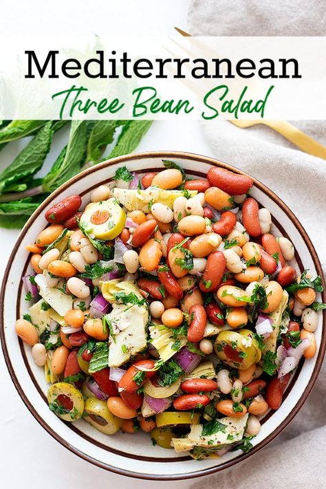 This Mediterranean three bean salad is made with your favorite beans, olives, artichokes and other Mediterranean vegetables and herbs. It's the perfect vegan side dish for summer and it takes only 5 minutes to put this healthy salad together. The best part is the fresh and delicious dressing! #beansalad #threebeansalad #beansaladrecipe #sidedishrecipe Three Bean Salad Recipe, Bean Salad Dressing, Mediterranean Vegetables, Mediterranean Recipes Healthy, Mediterranean Diet Recipes Dinners, Bean Salad Recipe, Three Bean Salad, White Bean Salad, Easy Mediterranean Diet Recipes