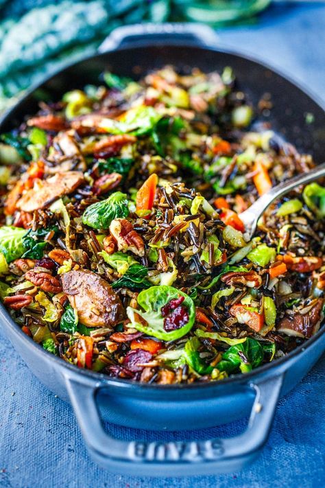 This Wild Rice Pilaf recipe is hearty, textural and savory. Nutty wild rice is paired with mushrooms, pecans, leeks, Brussels sprouts, and craisins. A lovely, colorful side dish that is vegan and gluten-free. Wild Rice Pilaf Recipe, Wild Rice Pilaf, Salty Recipes, Veggie Bowls, Wild Rice Recipes, Rice Recipes Vegan, Rice Pilaf Recipe, Pilaf Recipe, Pilaf Recipes