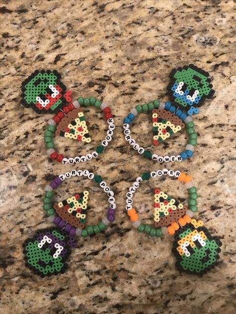 Turtle power kandi with TMNT perler and pizza slices #edmmusic #kandi #perler #TMNT Tmnt Kandi Pattern, Pizza Perler Beads, Rottmnt Bracelets, Ninja Turtles Perler Beads, Tmnt Perler Bead Patterns, Rottmnt Perler Beads, Tmnt Bracelet, Tmnt Pixel Art, Tmnt Perler Beads