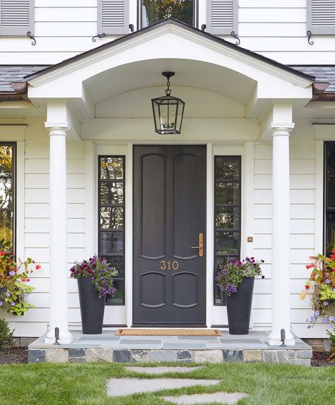 These striking, yet timeless hues prove your front door doesn't need to be bright to be bold. Whether your style is crisp and tailored or breezy and relaxed, these ideas for dark front door colors will give your home an entirely new look. #homeideas #frontdoorideas #curbappeal #frontdoorpaintideas #bhg Dark Front Door, Residential Front Doors, Kitchen Island Sink, Grey Front Door, Island Sink, Black Front Door, Lighting For Kitchen Island, Lighting For Kitchen, Farmhouse Chandeliers