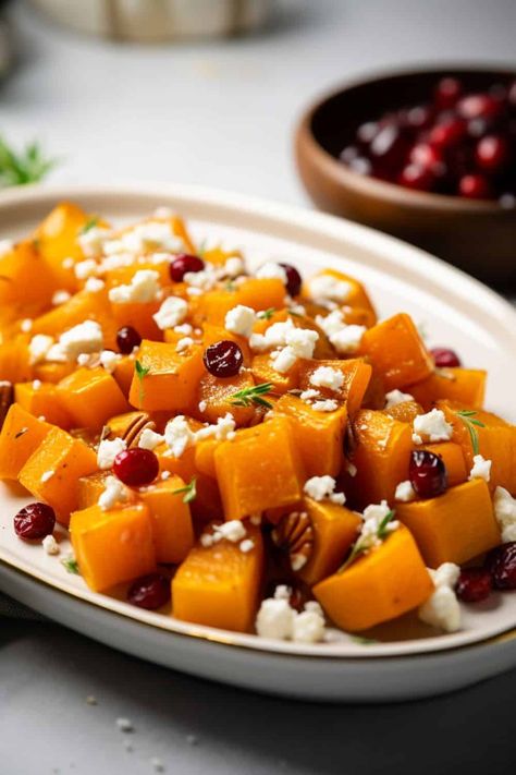 Delicious Honey Roasted Butternut Squash with Cranberries and Feta, garnished with fresh herbs, served as a vibrant, sweet, and savory side dish on a white plate. Honey Roasted Butternut Squash, Butternut Squash With Cranberries, Butternut Squash Benefits, Garlic Roasted Potatoes, Creamy Feta, Sweet Potato And Apple, Thanksgiving Recipes Side Dishes, Butternut Squash Recipes, Roasted Squash