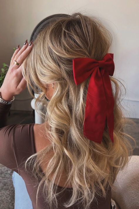 Woman with a half-up hairstyle featuring a classic red Christmas bow. Classic Red Christmas, Red Christmas Bow, Cute Christmas Hairstyles, Festive Hairstyles, Romantic Waves, Up Hairdos, Glamorous Christmas, French Twists, Classic Updo