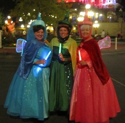 Flora, Fauna and Merryweather costumes from Halloween 2010. Flora Fauna And Merryweather Costume, Flora Fauna Merryweather Costumes, Costume Disney, Godmother Dress, Sleeping Beauty Fairies, Disney Sleeping Beauty, Fairy Godmother, Disney Costumes, Costume Dress