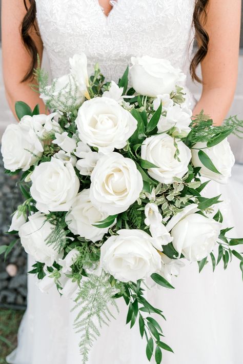 Bride in white dress holding a bouquet of white roses with greenery White Roses And Peonies Bouquet, Wedding Bouquet White Roses Greenery, White Roses Bride Bouquet, Classic Bouquet Wedding, White Rose Wedding Flowers, White Flowers Bridal Bouquet, Bridal Bouquet Fresh Flowers, White Rose Wedding Boquet, White Roses And Hydrangeas Bouquet