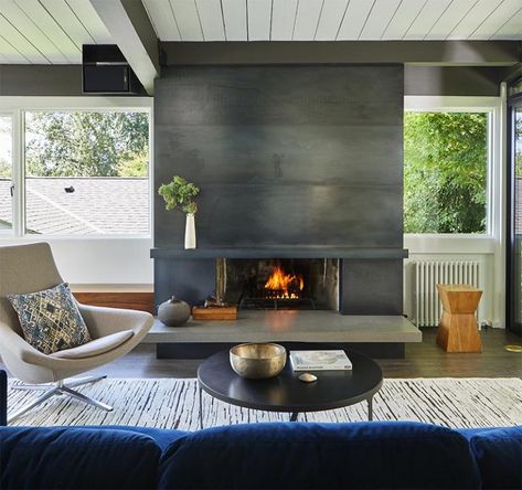 A Blackened Steel Fireplace Surround With A Concrete Hearth Is A Strong Look Inside This Mid-Century Modern House Blackened Steel Fireplace, Steel Fireplace Surround, Concrete Hearth, Fireplace Accent Walls, Modern Industrial Farmhouse, Steel Fireplace, Masonry Fireplace, Fireplace Tile Surround, Concrete Fireplace