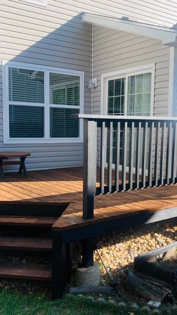 Brenda | DIY & Design on a budget | Latina on Instagram: "Deck Makeover 🖤 ✨  This 22 year old deck needed a refresh so bad and I didn’t love the cedar stain so nothing a fresh coat of new stain can’t fix!!   I used deck stripper and a power washer to strip off the floor stain completely and used @olympicstains on these colors:  Floors: Canyon Brown (one coat) Banister: Black (Behr’s tone-two coats)   Details in my highlights ✨  #thepowerofpaint #buildergradeupgrade #olympicstain #homedepotdeckp Two Tone Stained Deck, Deck Colors For Red Brick House, Back Door Steps To Patio, Deck Painting Ideas, Black Porch, Cedar Stain, Deck Makeover, Porch Paint, Design On A Budget