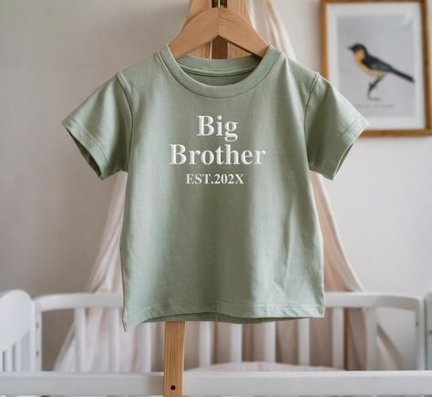 Embroidered Est Big Brother T-shirt This is the perfect t-shirt for your baby announcement, birthday or simply just as a casual t-shirt for your child. We strive for excellence and ensure you receive the best service and quality at all times. This also makes a great gift for a dear friend or loved one. ★ T-shirt Details - Fabric weight: White 160gsm - Material: 100% cotton - Cotton rib crew neck - Taped back neck - Tubular knit for shape retention *Garment sizes are approximate* Would recommend Brother Announcement, Big Brother Announcement, Big Brother Gift, Big Brother Tshirt, Big Brother Shirt, Brother Shirts, Little Brother, Gifts For Brother, Tailored Shirts